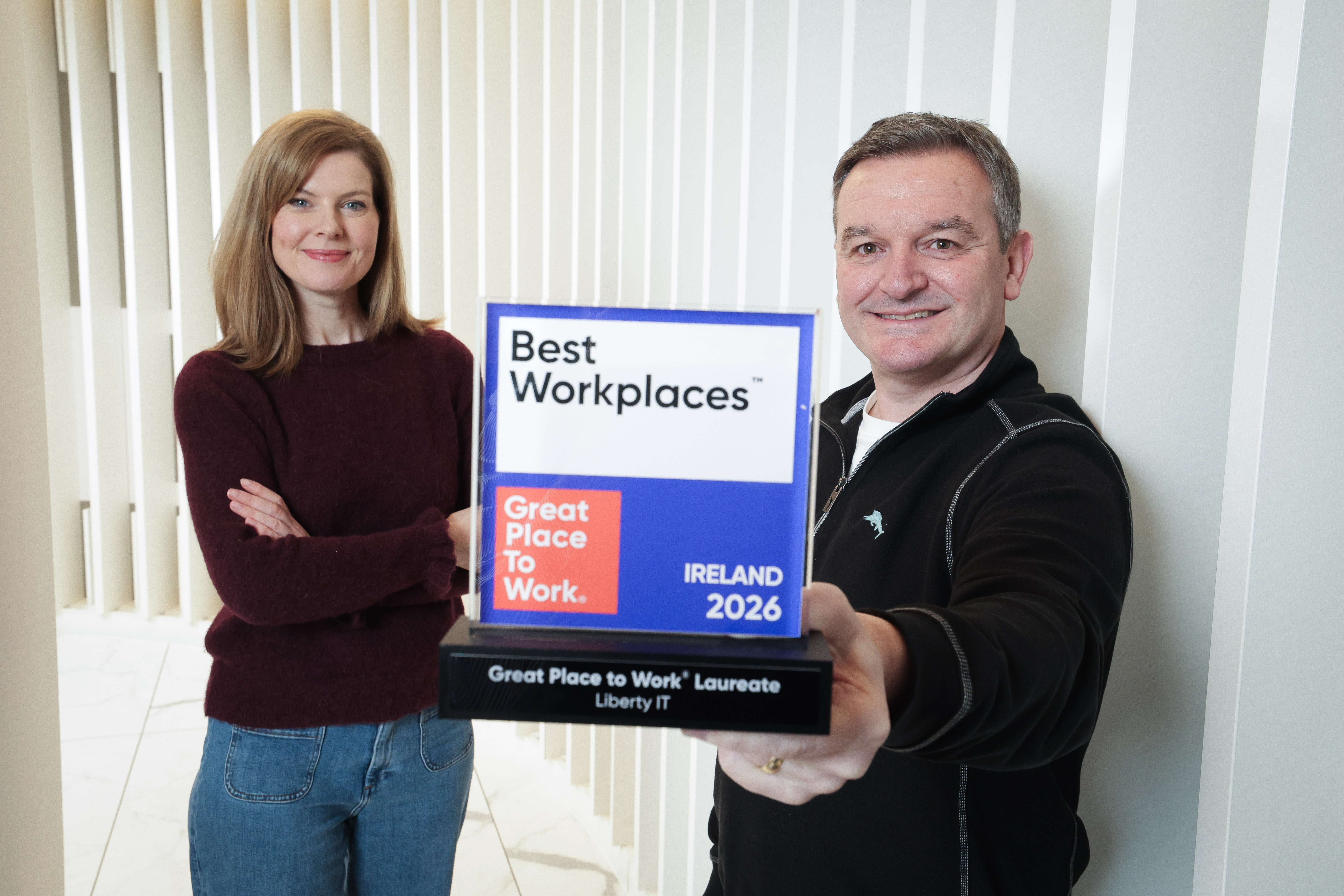 Tony Marron, Managing Director of Liberty IT and Emma Mullan, Senior Director of Talent, smiling with a Great Place to Work Ireland award