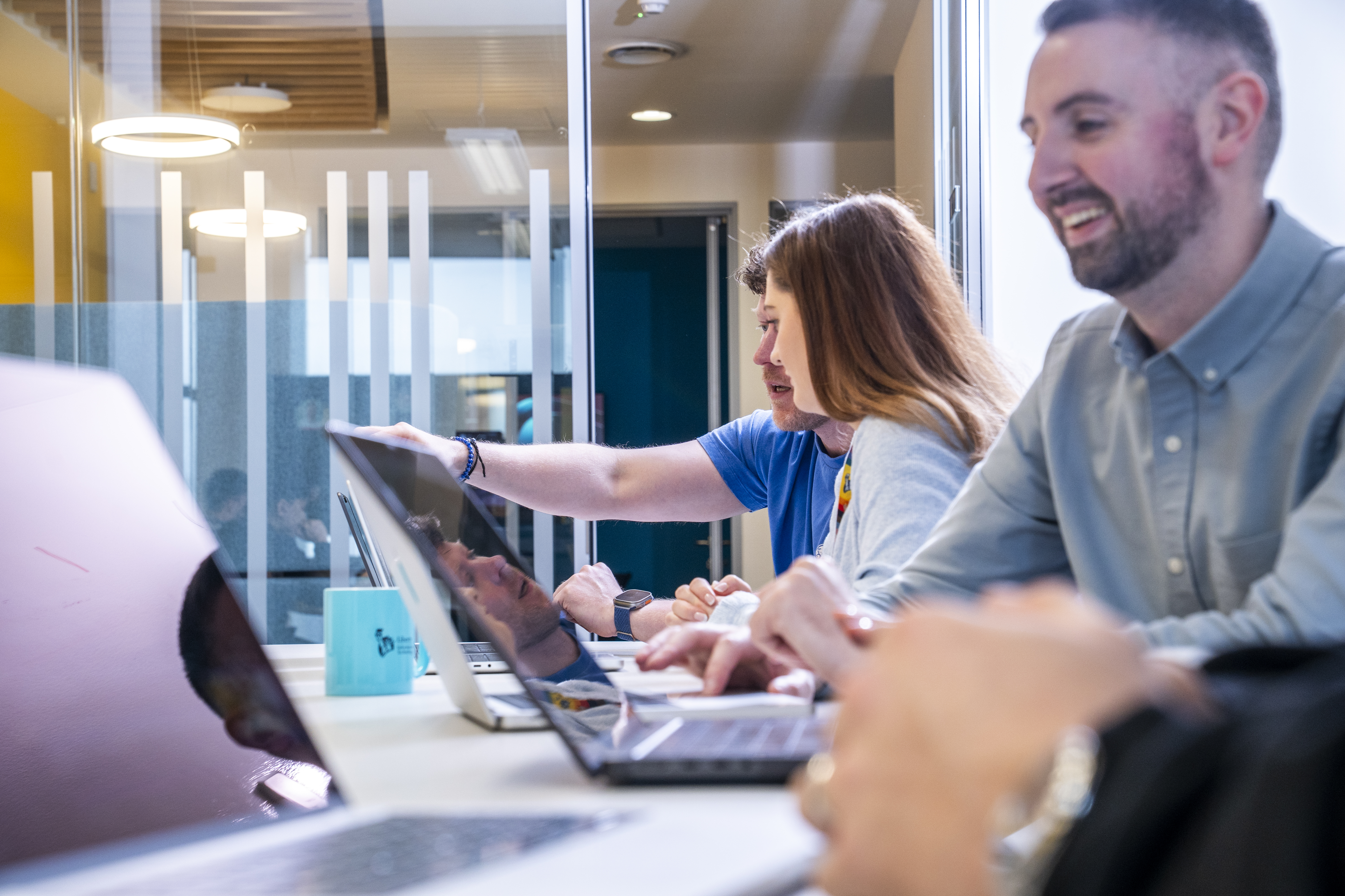 Employees connecting in a Liberty IT workspace.