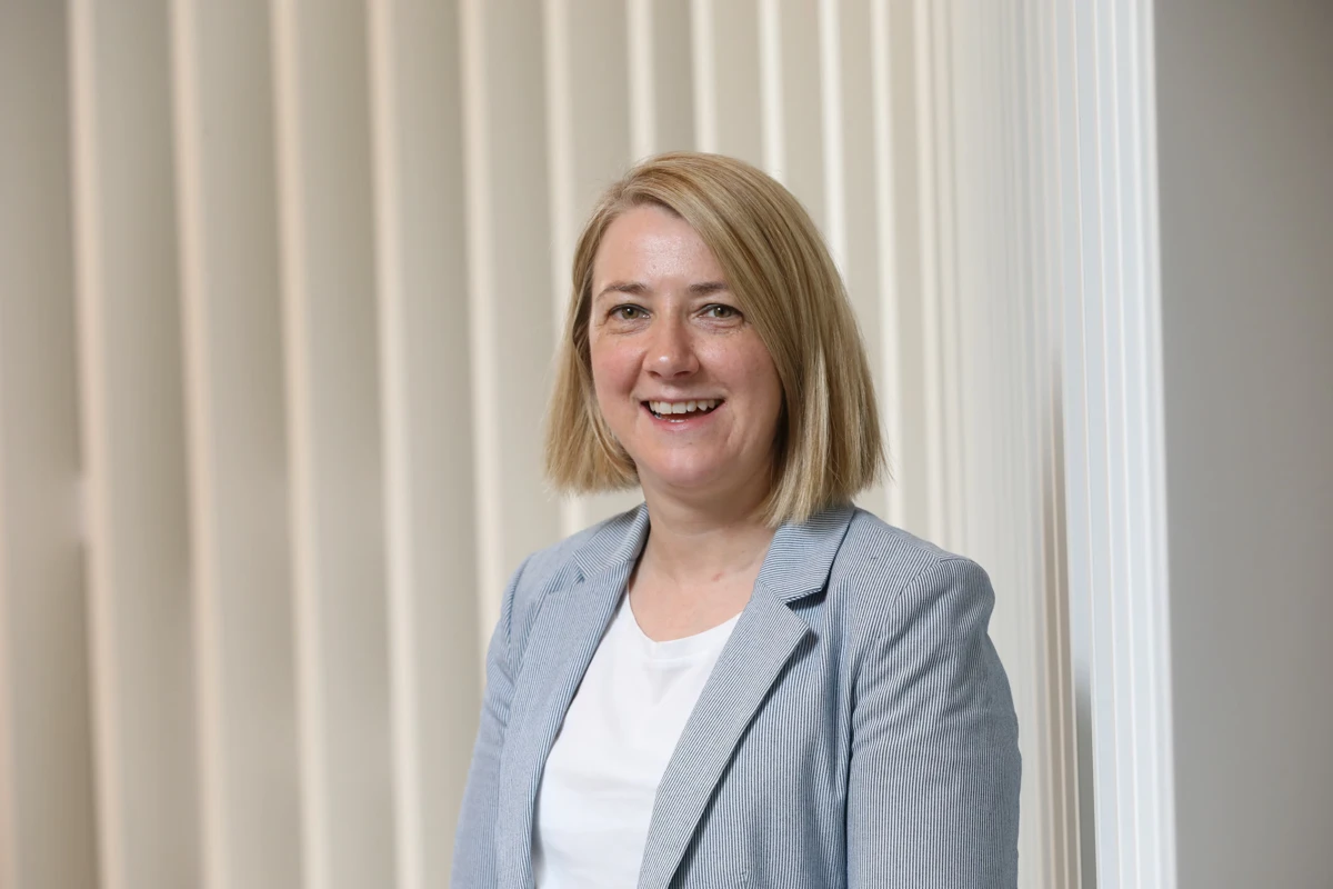 Sinead, Senior Director of Engineering, smiling in an office setting