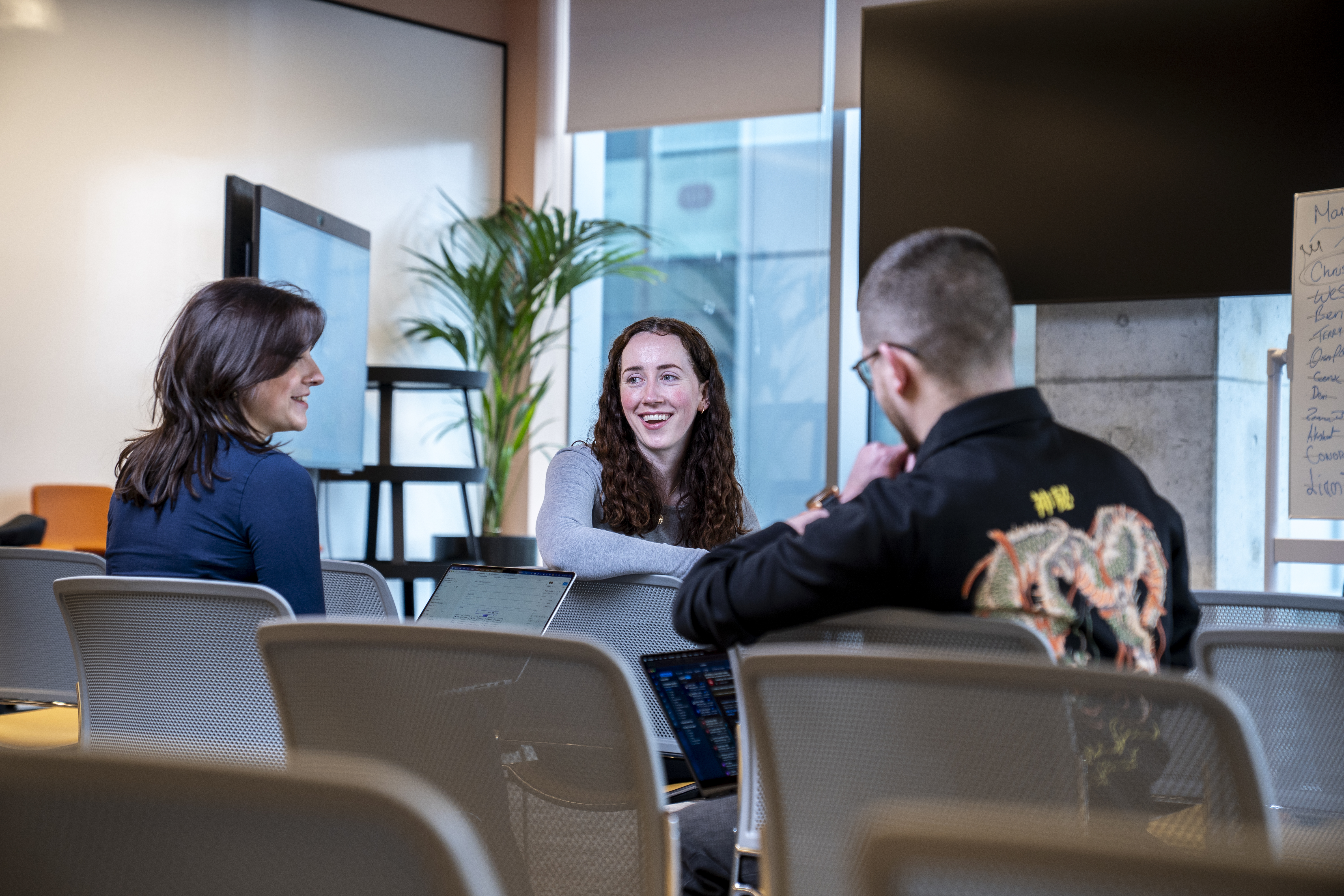 Employees collaborating during a meeting in the Liberty IT Galway office.