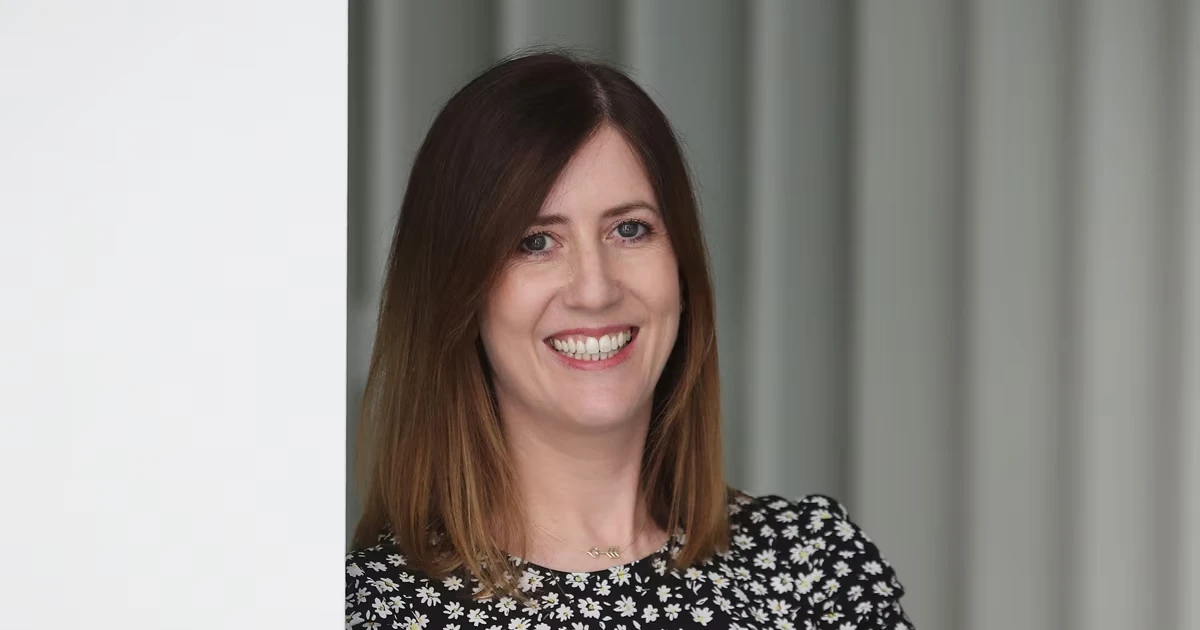 Claire, Director of Engineering, smiling in an office setting