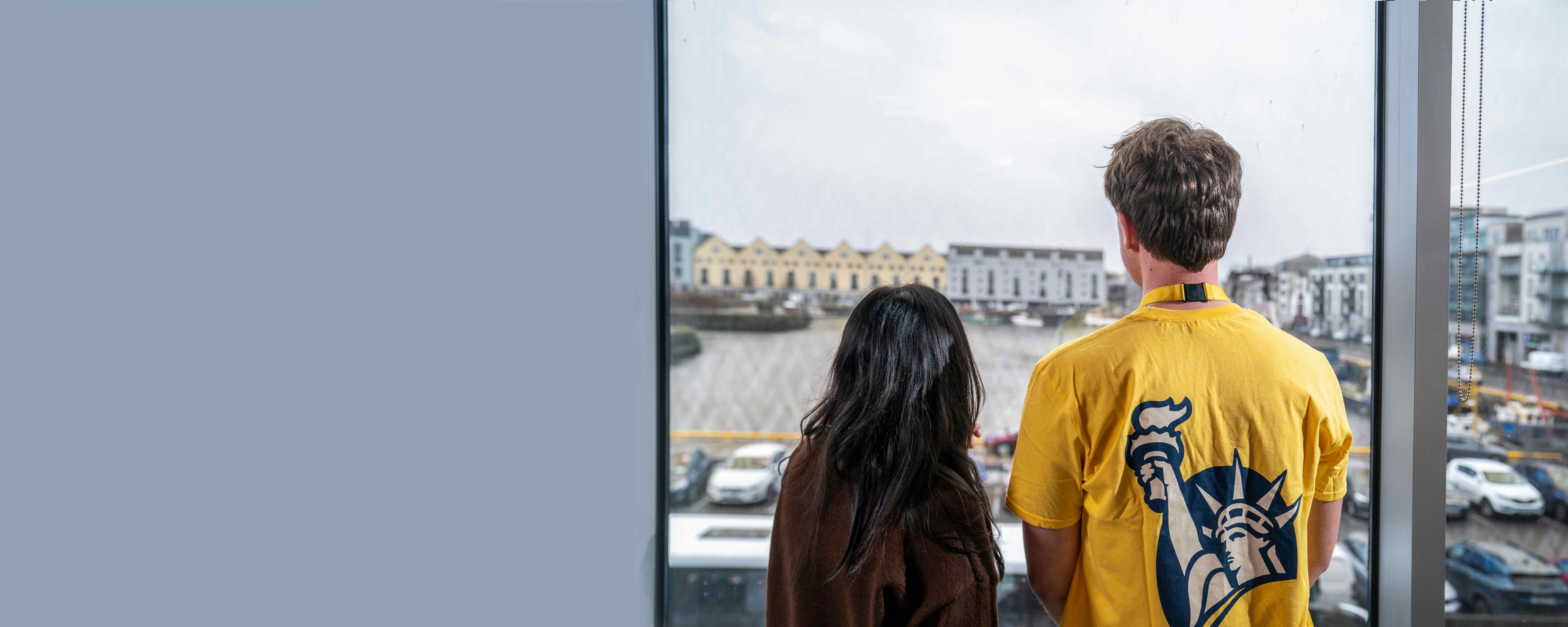 Employees looking out over the Galway waterfront from the Liberty IT office.