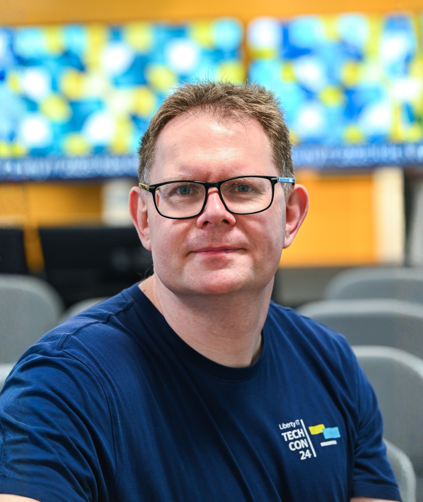Garth smiling in a meeting environment