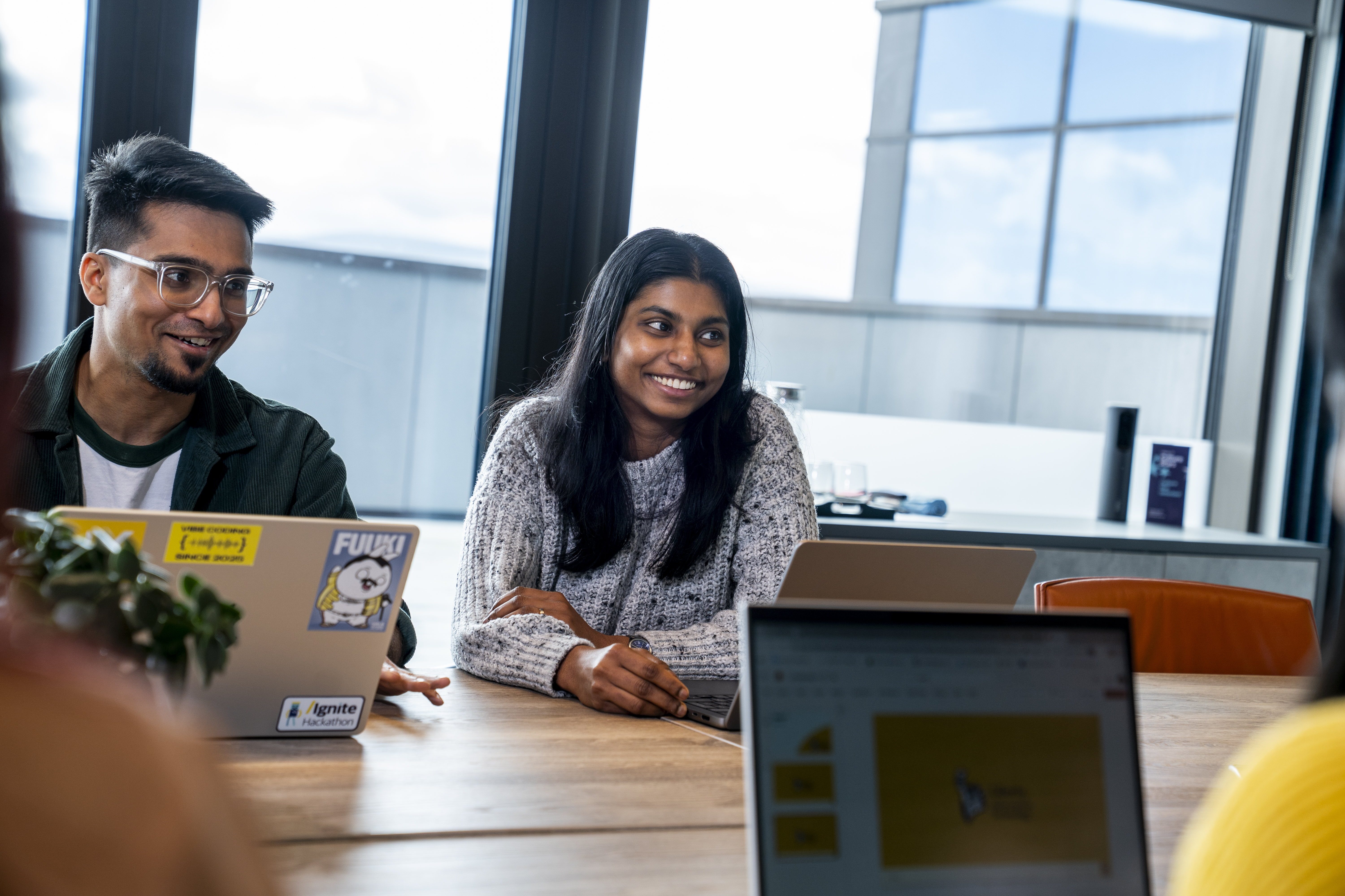 Two employees smiling in a meeting