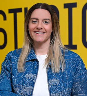 Headshot of an employee in front of a yellow background