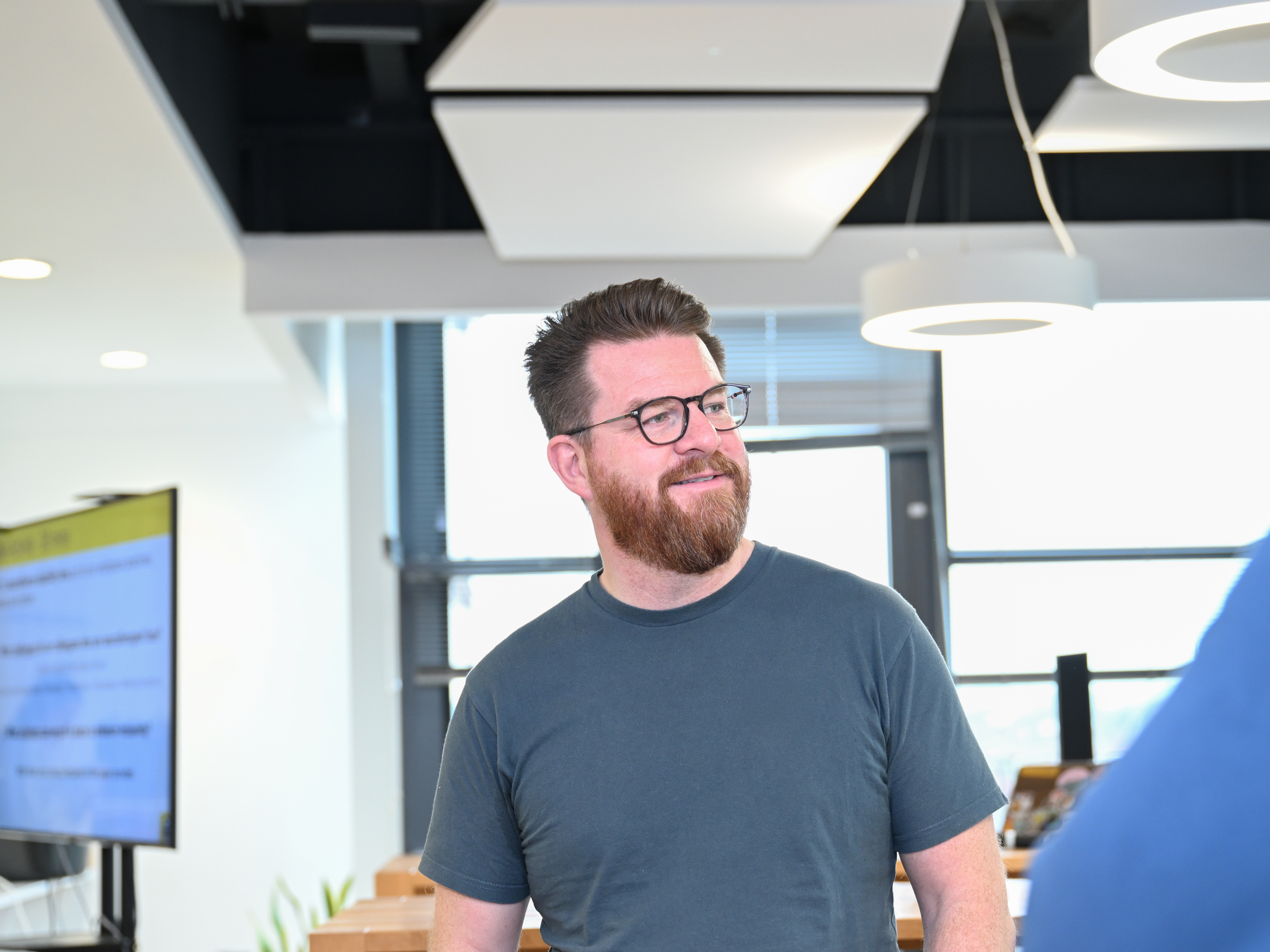 Declan, Engineering Manager, smiling in an office setting
