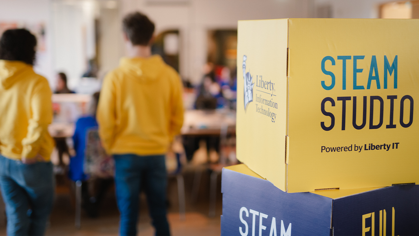 STEAM Studio session with two ambassadors in yellow hoodies with cube that says STEAM Studio