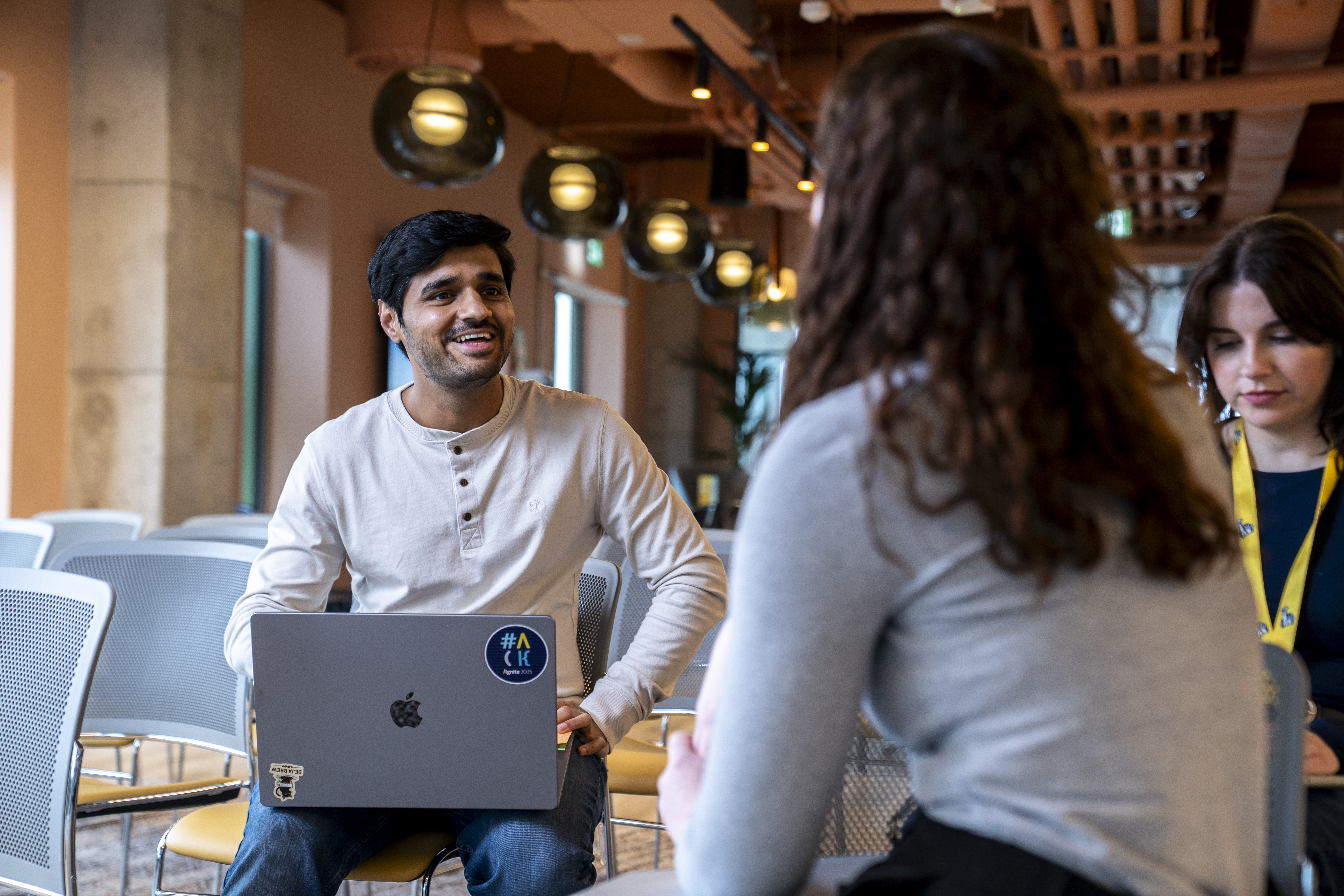 Picture of employee smiling with laptop