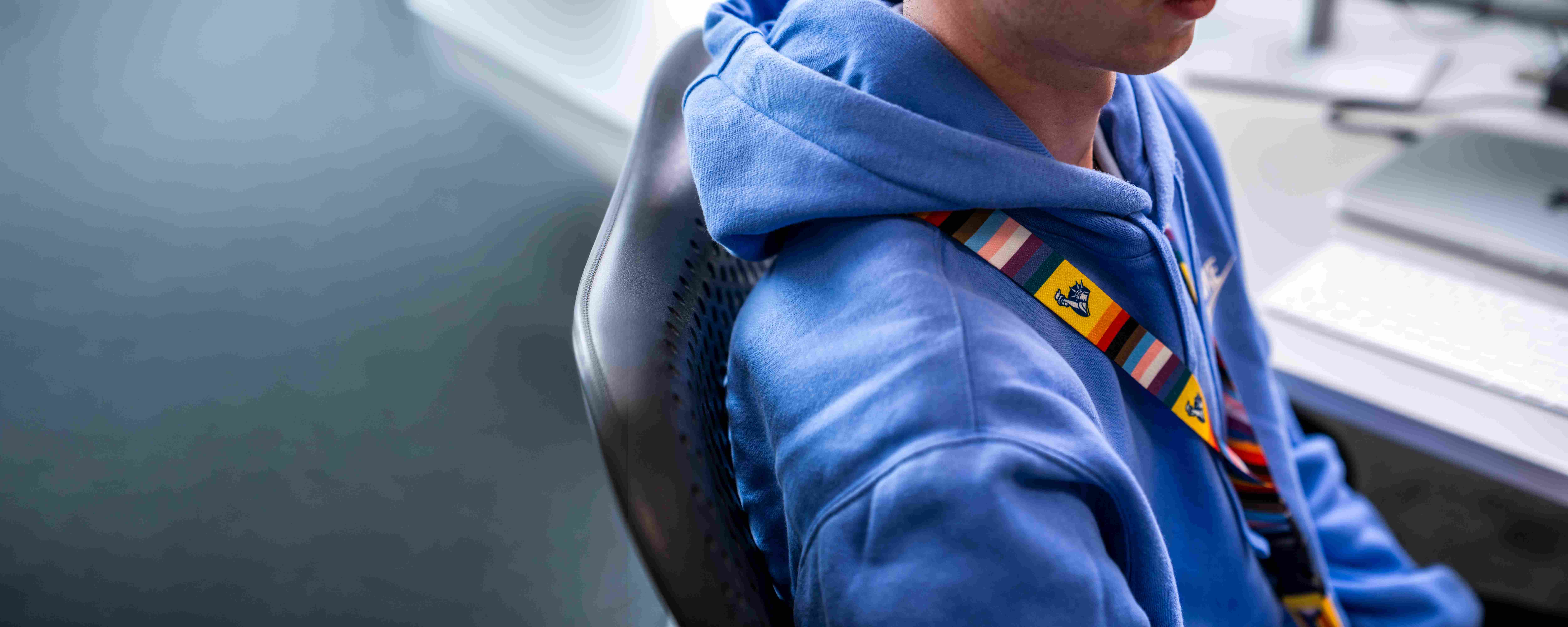Employee with pride lanyard