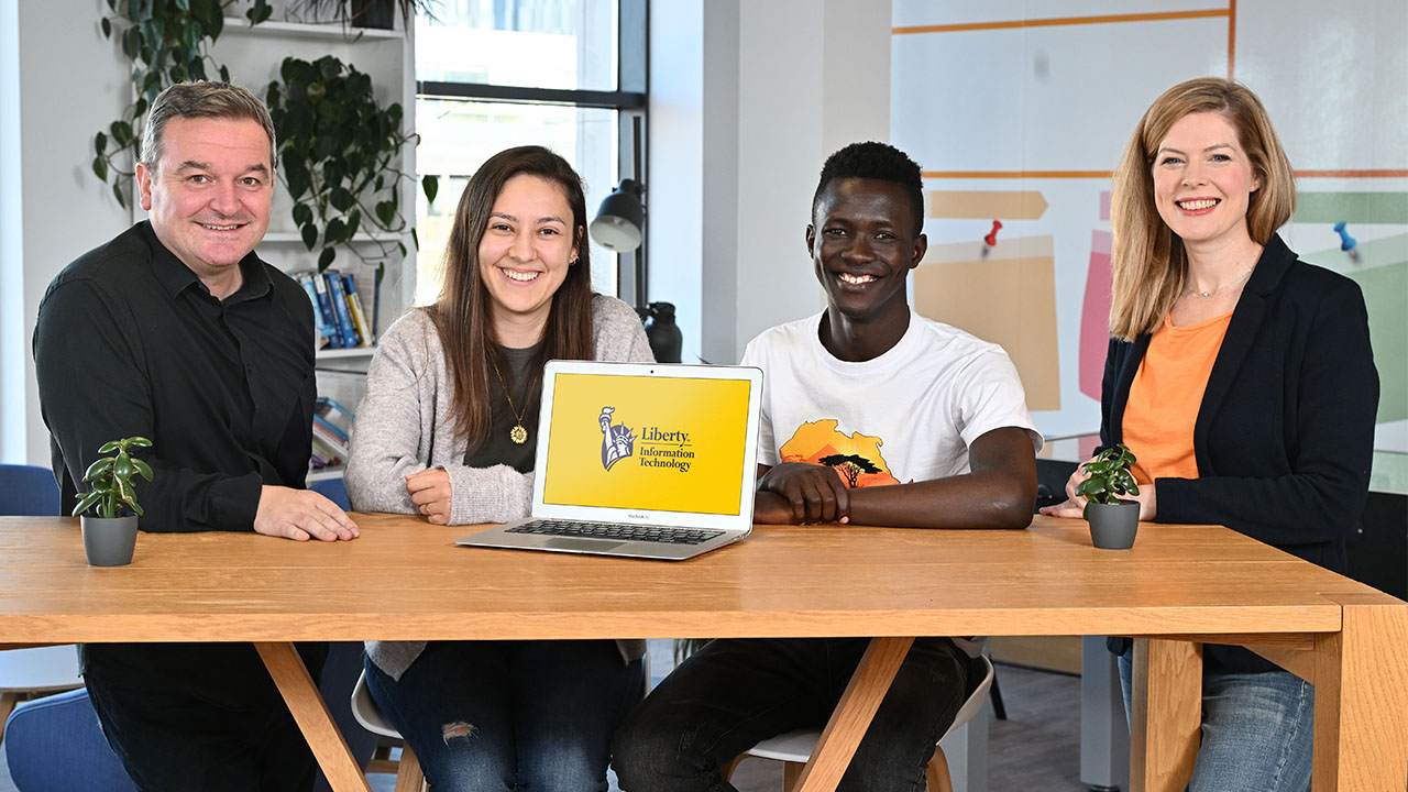 Pictured, are: Tony Marron (left), Managing Director of Liberty IT and Senior Director of Talent, Emma Mullan (right) are joined by Associate Software Engineers Paula Santkiewick and Young Israel Izere.